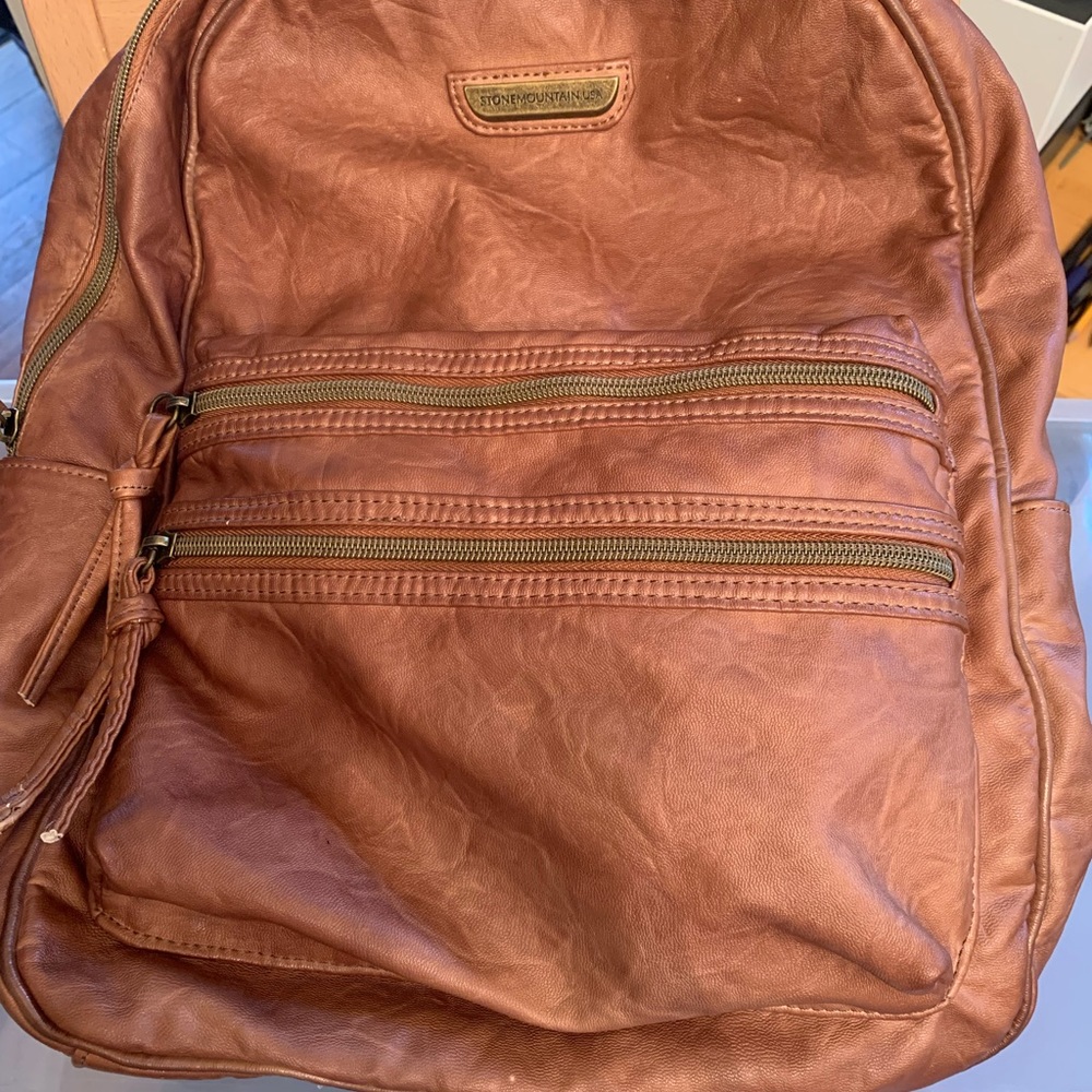 Faux leather, large capacity backpack. Excellent condition. Used once.